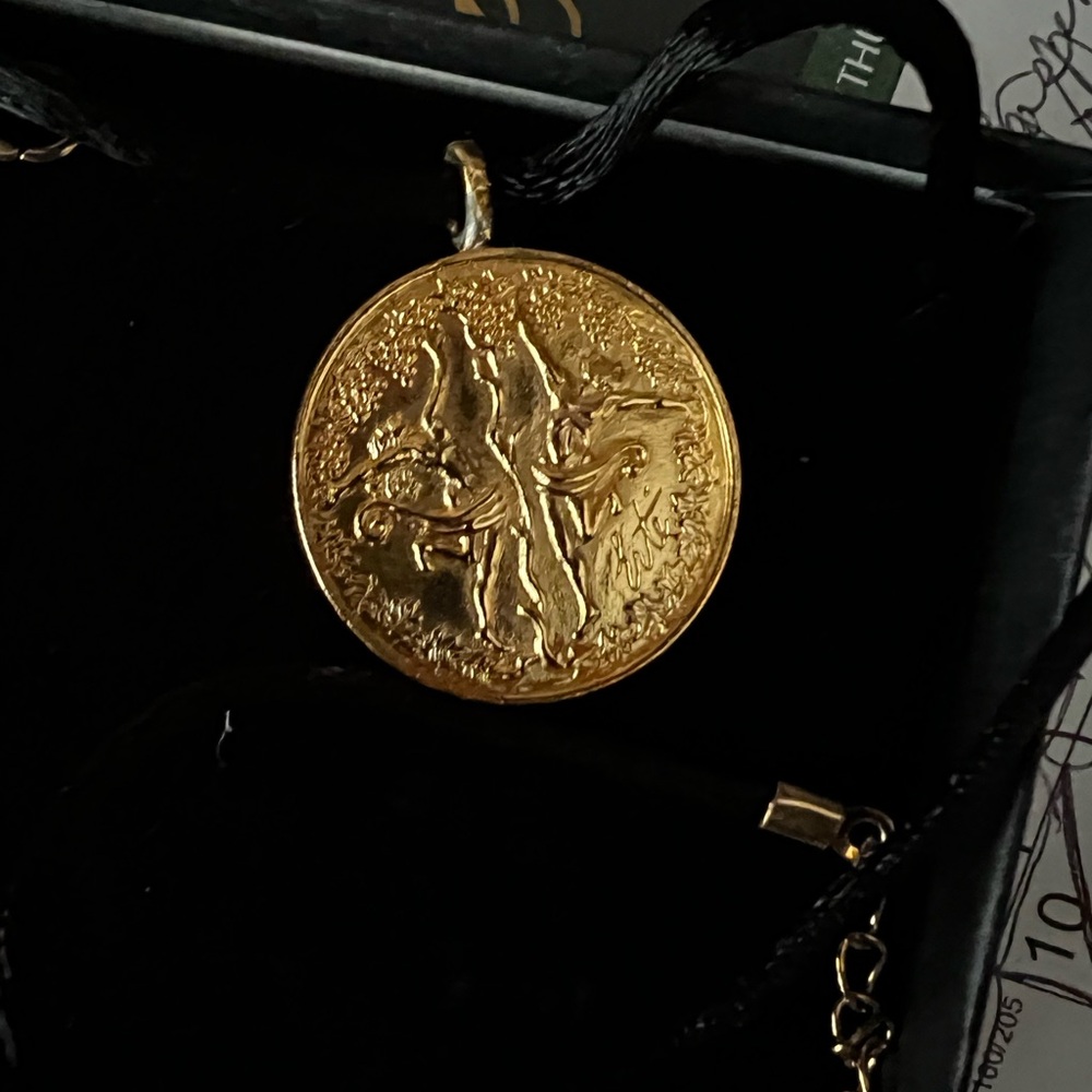 ERTE ADAM & EVE LOVE MEDALLION ON BLACK CORD.
